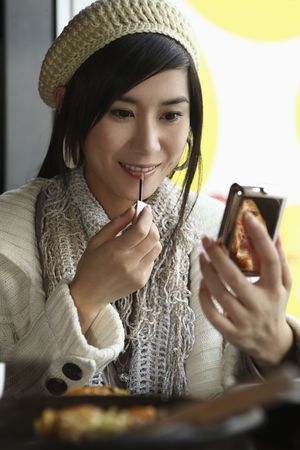 Woman applying lip glossの写真素材