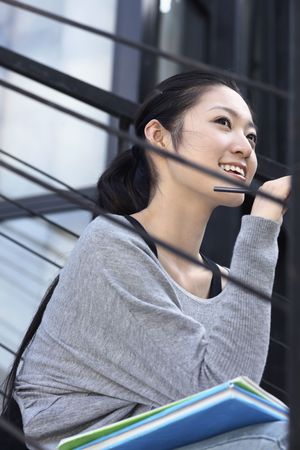 Woman holding pencil, contemplatingの写真素材