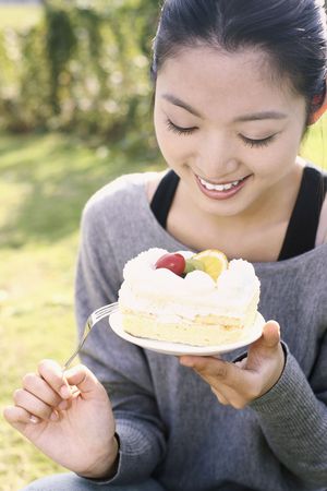 Woman holding a plate of cakeの写真素材