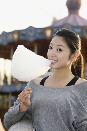Woman enjoying cotton candyの写真素材