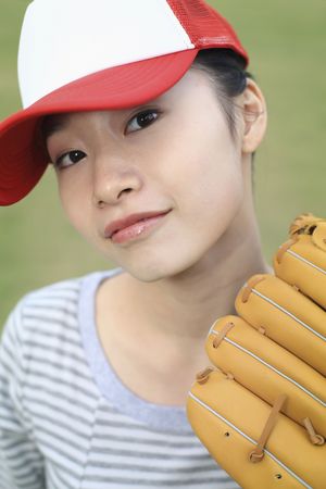 Woman with cap and baseball gloves