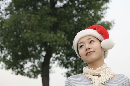 Woman with Christmas hat smilingの写真素材