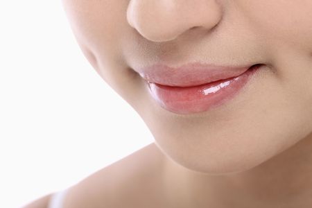 Focus on young woman's mouthの写真素材