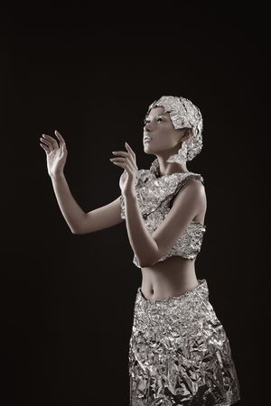 Woman wearing foil accessories with hand gesturesの写真素材