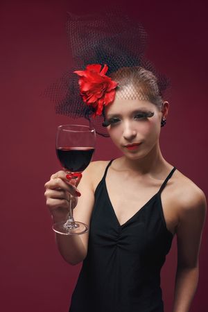 Woman with net and flower decorating her hair holding wine glassの写真素材