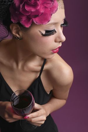 Woman with net and flower decorating her hair holding wine glassの写真素材