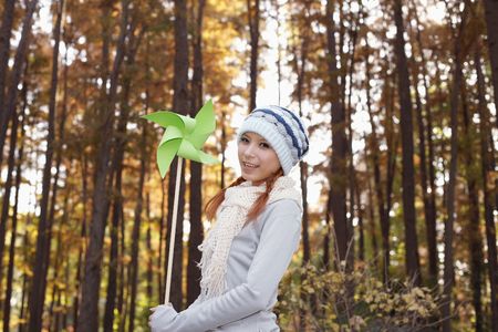 Woman holding pinwheel, smilingの写真素材