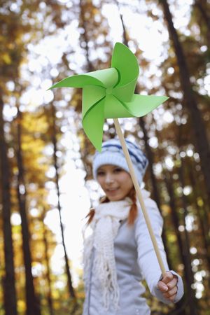 Woman holding pinwheel, smilingの写真素材
