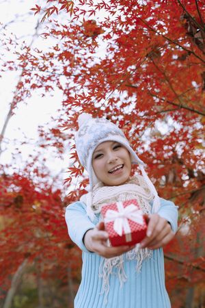 Woman smiling while holding giftの写真素材