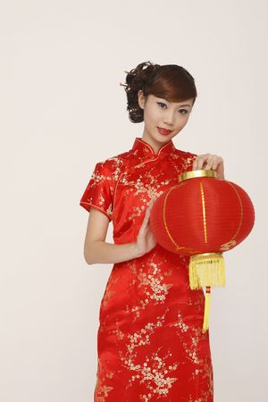 Woman in red cheongsam holding lanternの写真素材