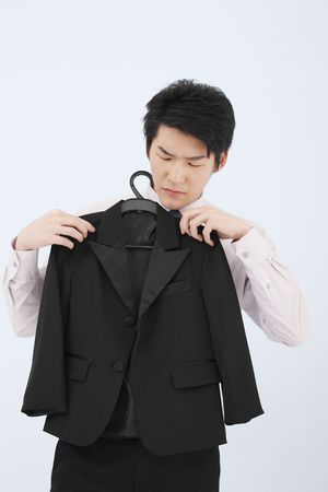 Man holding suit on coathangerの写真素材