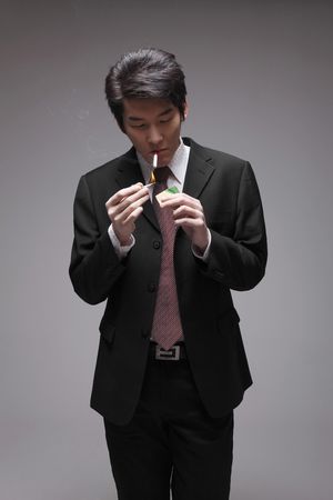 Man lighting up cigaretteの写真素材