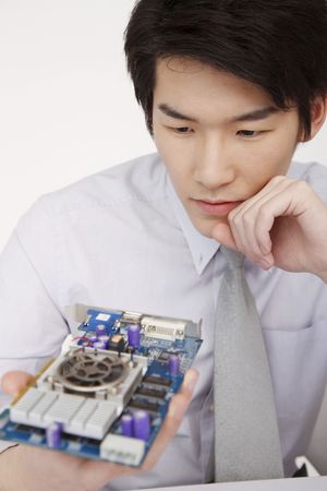 Man staring at video card, thinking