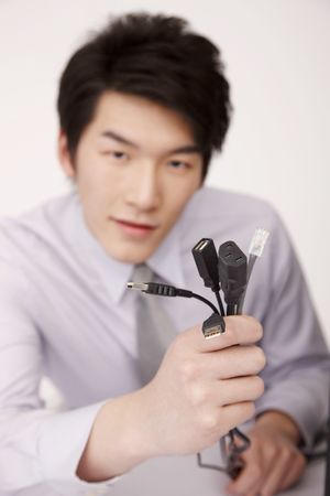 Man holding computer cableの写真素材
