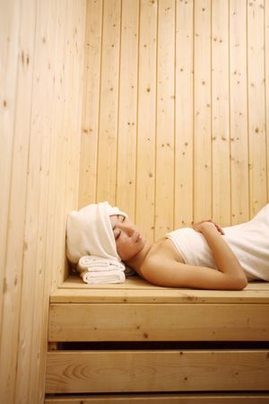 Young woman relaxing in saunaの写真素材