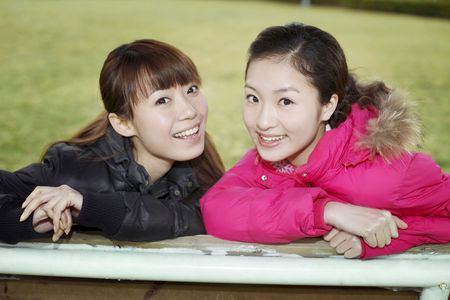 Young women posing on swingの写真素材
