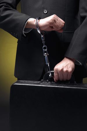 Businessman handcuffed to briefcaseの写真素材