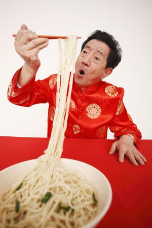 Senior man enjoying his bowl of noodles