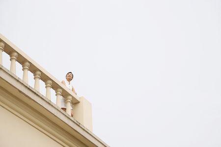 Woman enjoying the view from the top of balconyの写真素材