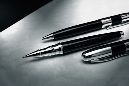 Elegant black pen on silver deskの写真素材