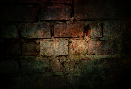 Old vintage brick wall background in dark atmosphereの写真素材