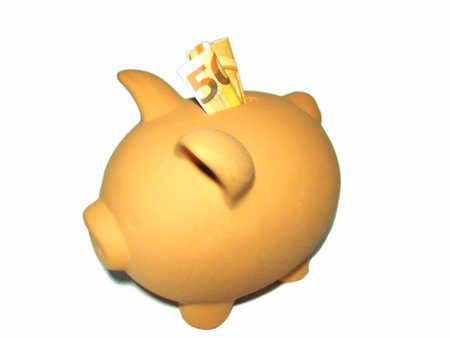 Terracotta piggy bank with 50 euros on a white backgroundの写真素材