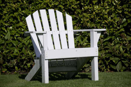 One white chair close-up view on the lawn.の写真素材