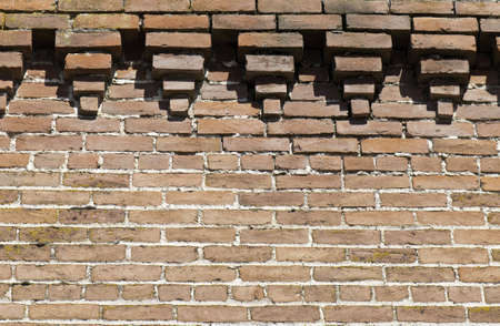 Brick wall with fancy outcropping at the top.の写真素材
