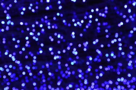 Blue and silver defocused lights background. Abstract bokeh lights.の写真素材