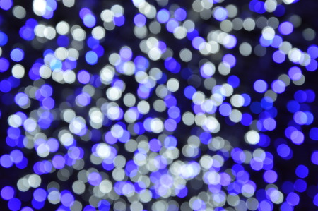 Blue and silver defocused lights background. Abstract bokeh lights.の写真素材