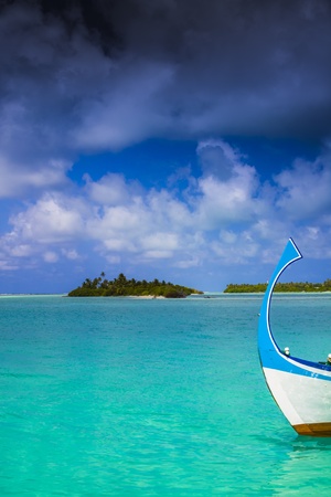 dark clouds over an maldivian island with a boat in front ofの写真素材