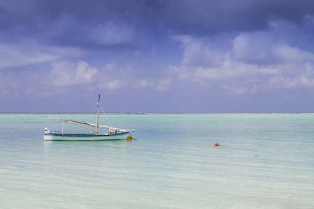 small sail or sailing boat on the sea with cloudy sky