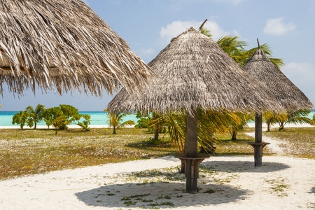 sunshades at a tropical beach with blue skyの写真素材