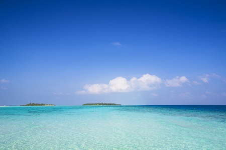 background of a tropical island in a turquoise sea with blue skyの写真素材