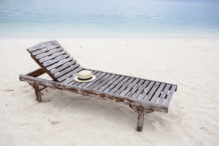 sun bed with sun hat at the beach with turquoise seaの写真素材