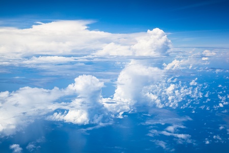 blue sky with white clouds high over the seaの写真素材