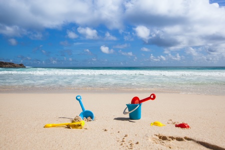 background of some toys for playing in the sand at a beach with blue skyの写真素材