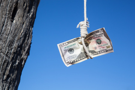 one fifty Dollar banknote hanging in the air at a  gibbet cord: Concept for Dollar crisis, financial benefit or trap   の写真素材