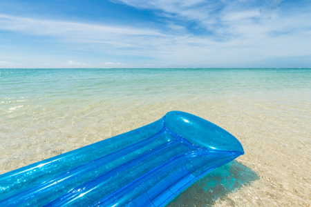 travel background with a blue air mattress floating in a turquoise sea and inviting to relax, Mauritius; Africaの写真素材