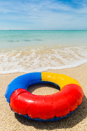 travel background with colorful inflatable swim ring at the beach in front of the turquoise sea, Mauritius, Africaの写真素材