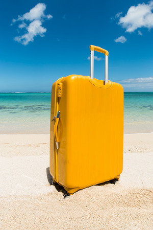 yellow trolley standing in the sand of a beautiful beach with a turquoise seaの写真素材