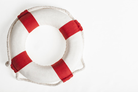 red and white lifesaver on a white background concept and symbol for security and dangerの写真素材
