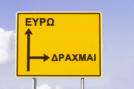 Yellow European direction sign, showing the way to Euro and to the old currency Drachma. Financial concept for the greek debt crisis with the words Euro and Drachma in greek letters.の写真素材
