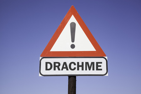 red and white warning triangle with the german word Drachme for the greek currency. Financial concept for the greek debt crisisの写真素材
