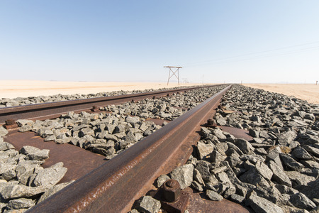 Rusty rail track in the Namib desert leading to the horizon, Namibia, Africa. Concept for vintage traffic or the way to business successの写真素材