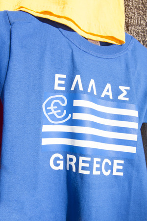 Blue and white greek flag with a Euro currency sign on a t-shirt. Financial concept for the greek Euro crisisの写真素材