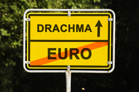 yellow european town sign, showing did Greece is leaving the euro and is on the way launching the old currency Drachma. Financial concept for the Greek debt crisis.の写真素材