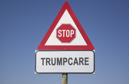 red warning triangle with a stop sign and the words Trumpcare, political or social concept for american healthcareの写真素材