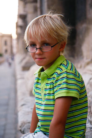 Happy and smiling little boy on a tripの写真素材