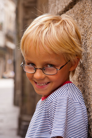 Happy and smiling little boy on a tripの写真素材